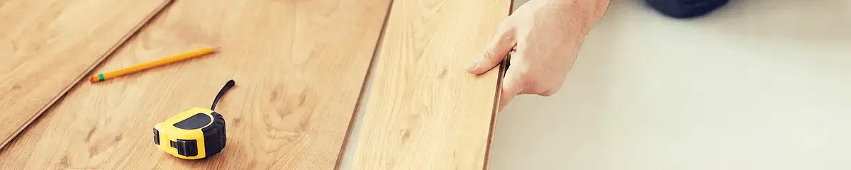 A professional installing wood flooring in Saint Louis, MO