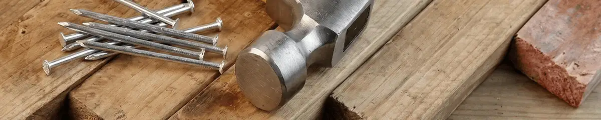 Hammer and nails on hardwood flooring boards in Saint Louis, MO