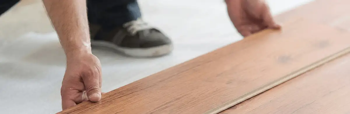 A professional installing laminate flooring in Saint Louis, MO