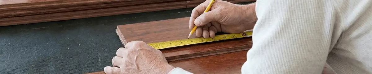 A professional installing wood flooring in Saint Louis, MO